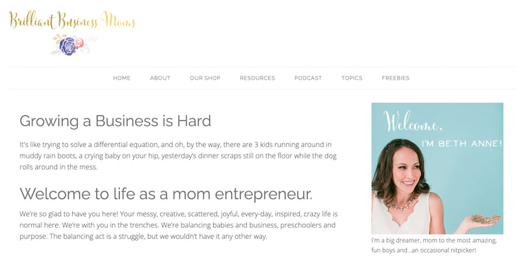 Brilliant Business Moms’ About page on the right side is a woman wearing a scalloped top and holding up her left palm to the sky