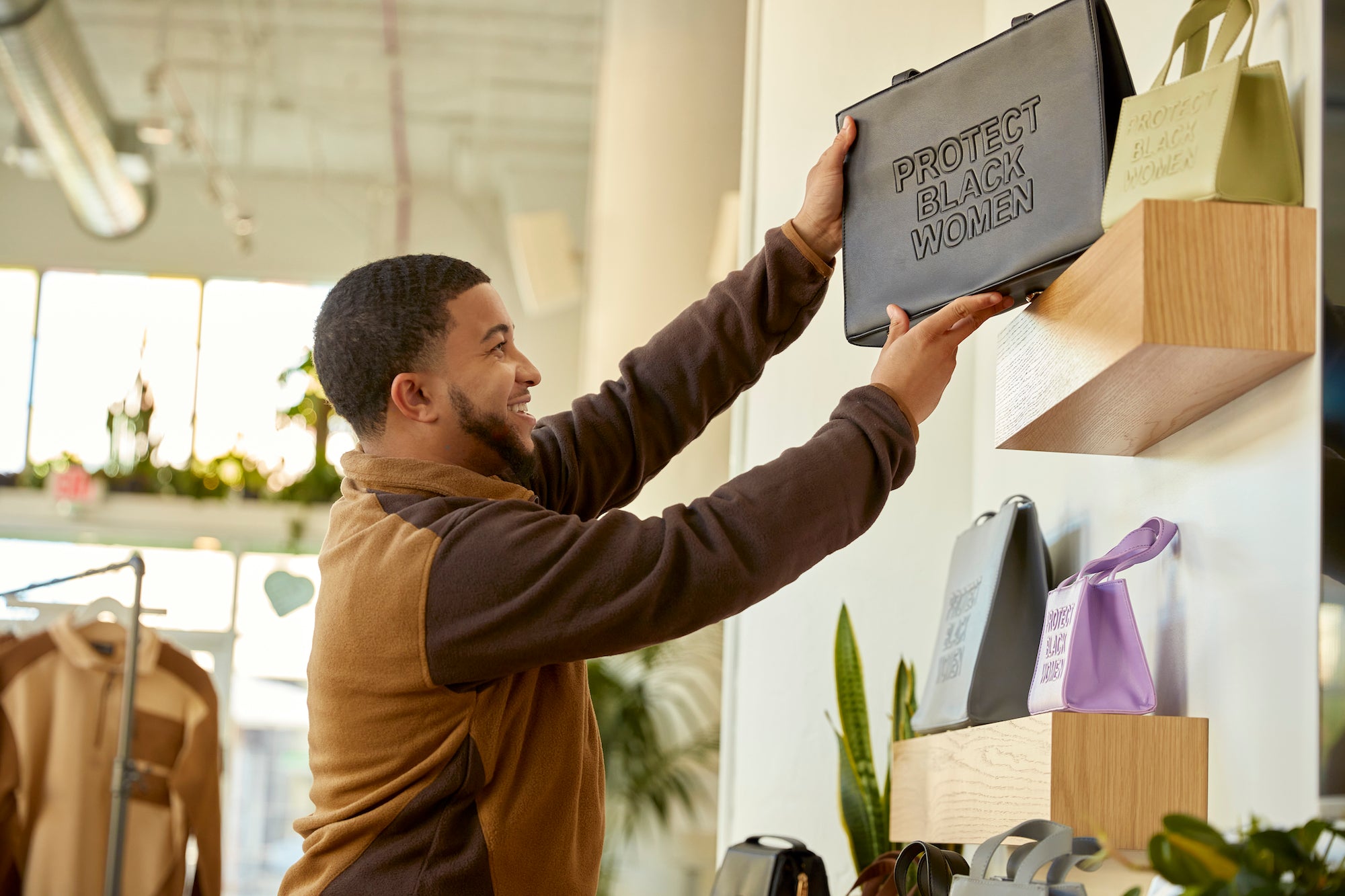 CISE founder Blake Van Putten holding one of his purses