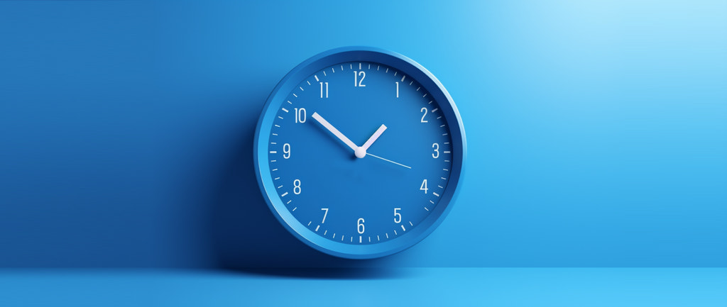a blue wall clock: best time to post on linkedin