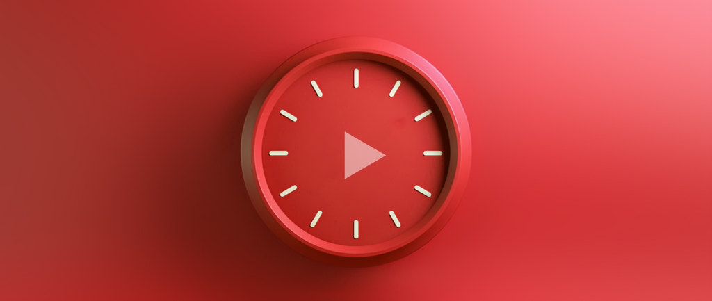 a red clock with the YouTube play button in the middle: best time to post youtube shorts
