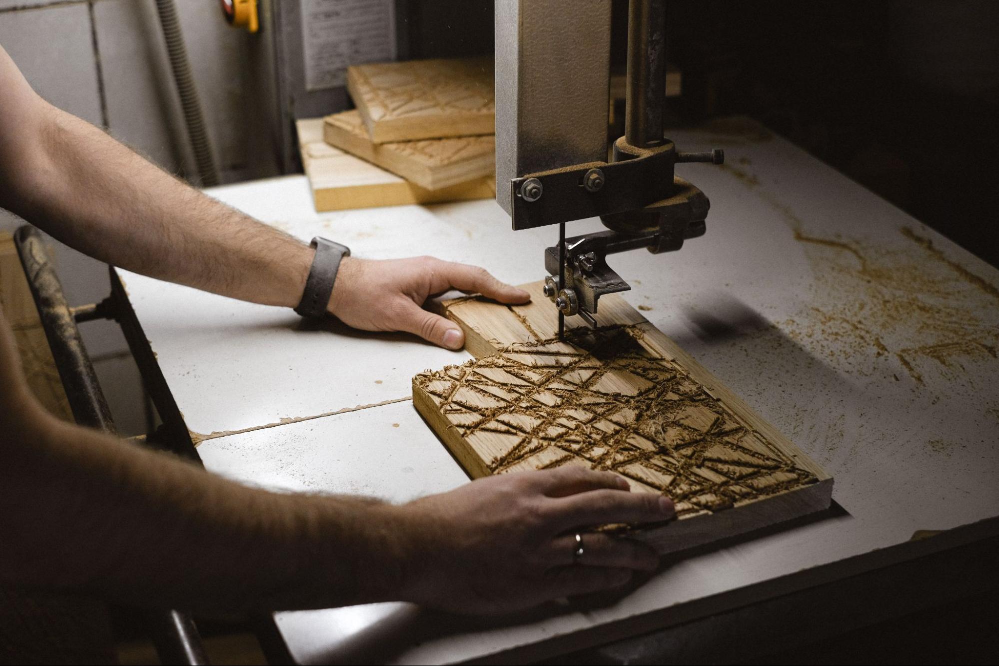 person-cutting-pattern-into-wood-on-cnc-machine