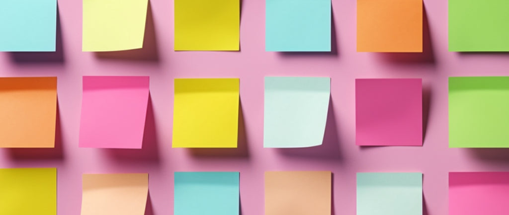 three rows of sticky notes of varying colors on a wall: product concept